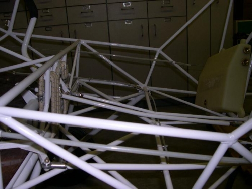 Bend in flap push tube to clear seat