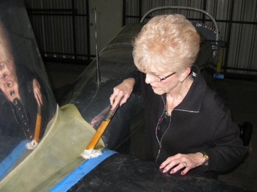 Charlotte spreading epoxied glass beads on the empennage fairing.