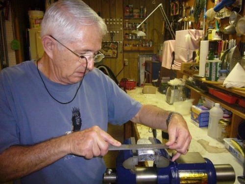 Filing one of the lead weights.