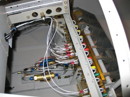 Wires coming thru subpanel and attaching to tabs on switches.