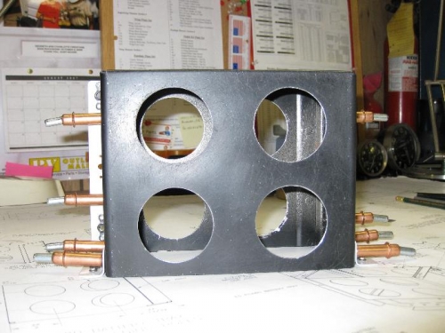 Battery box with mounting flanges clecoed.