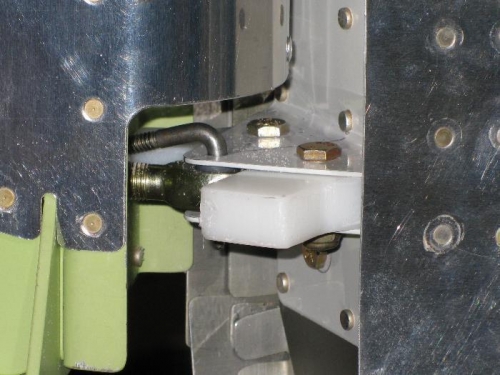 Plastic stop sandwiched between hinge halfs and bolted.