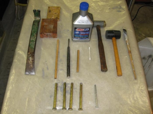Drift pins, mallets punches, oil, and pry bar.