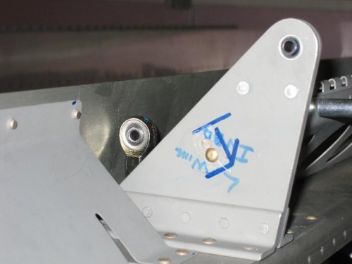 Aluminum stop angle removed from the left inboard aileron hinge bracket. Filled holes with rivets.