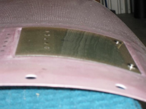 Closed view showing the slight bulge from flush at the spring hinge.