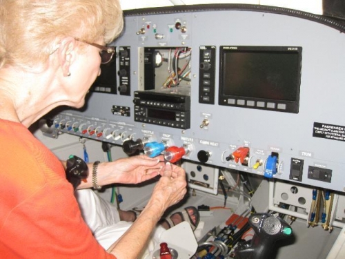 Charlotte applying the remaining labels to the intrument panel.