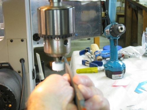 Reducing bushing OD using a file and drill press.
