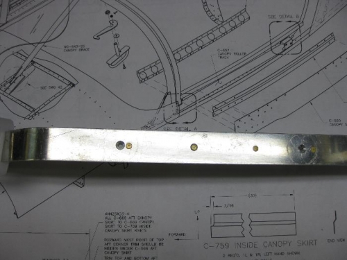 Slider spacer/rail showing screw holes and rivets.
