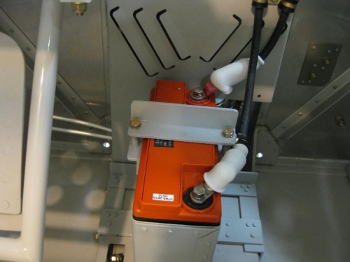 An adel clamp attached to the hold-down supports the negative cable going to the FW.