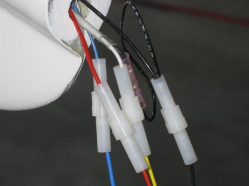 Wires crimped to pins and inserted into the cirular connectors.