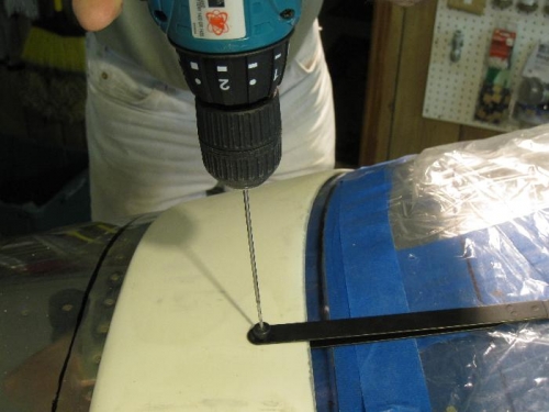 Using hole finder to drill skirt rivet holes.