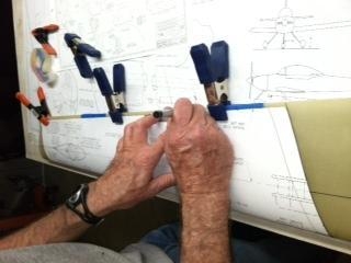 Tracing the template onto a main gear leg fairing.