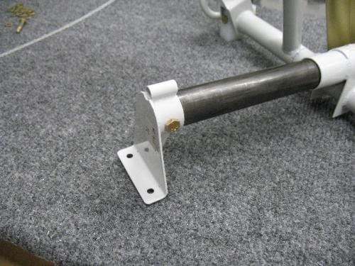 Drilled bolt through slide tube socket, this part attaches to the floor