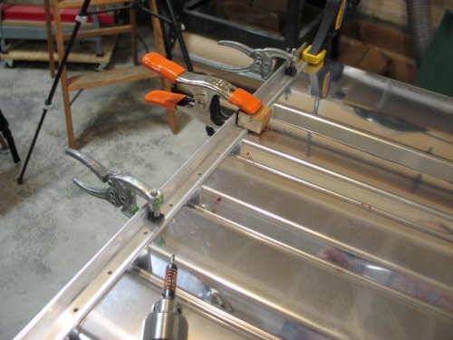 Clamp angle to seat back and drill.