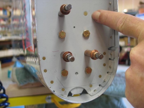 Pointing to 1 of 4 tie down rivets.