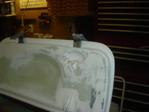 Aft hinge pocket covered and 'relieved' to avoid gas strut & bracket