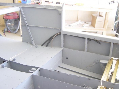 Rear seat pans riveted. Shows elec conduit and ant cable