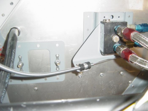 Control cable bracket mounted between valve and firewall