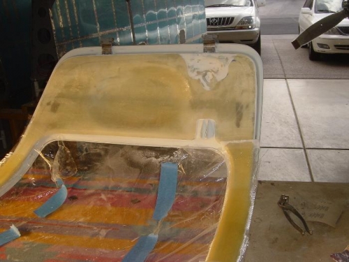 Vertical door posts strengthened w/ staggered lay-ups