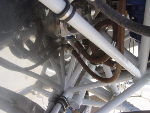 Fuel return line attached to firewall