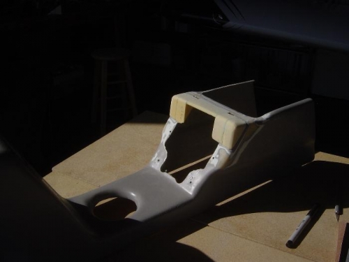 Upper portion of center console built up for vertical Autopilot mount