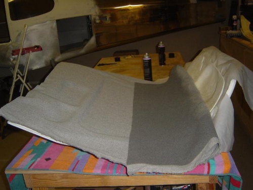 Glueing the tweed fabric to the foam backed door liner.