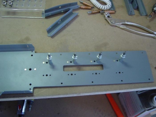 Install nutplates in mounting tray