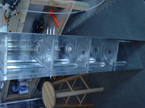 I found it easier to rivet and reach the nose rivets by standing on its end outside of the cradle,