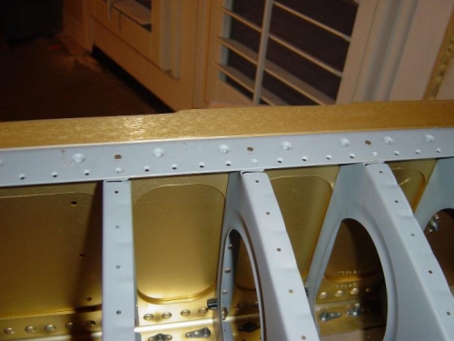 An3263-4 rivets in forward most hole of rib flange tab