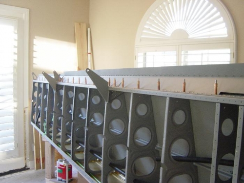 Riveting both gap seals to rear spar