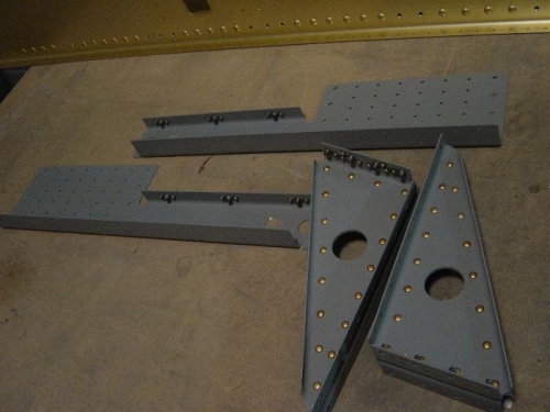 Riveted together seat rail supports