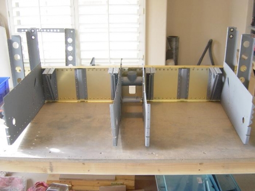 Inboard and outboard seat ribs attached to the AFT center section