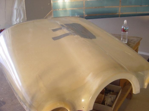 Duct tape applied to hold oil door flush during lay-up