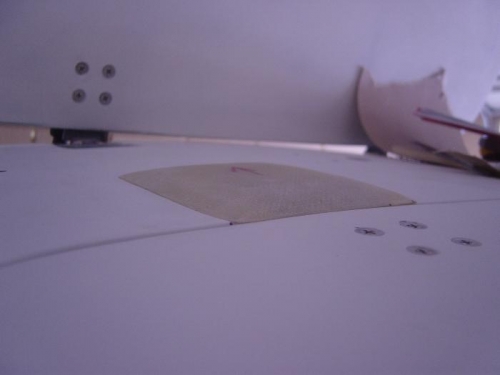 Fiberglass hinge cover sitting in its position covering the right aft hinge