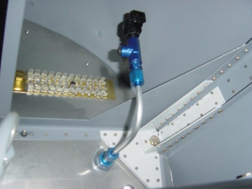 Attached to the firewall and to the hose that attaches to the engine