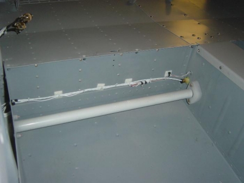 Aft tunnel 'conduit' epoxied for rear left seat headset cable