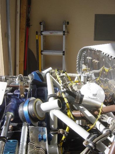 Harness supported across engien mount cross member