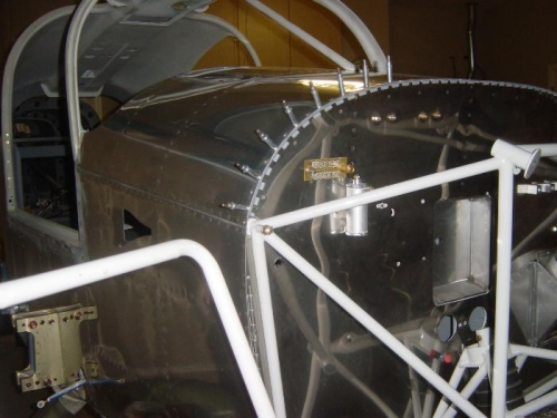 Finishing riveting the right side cowl hinge