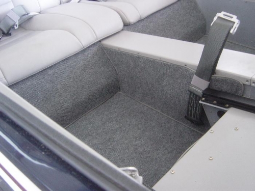 Pilot/copilot lap seatbelts installed and side carpet pieces in place to cover them.