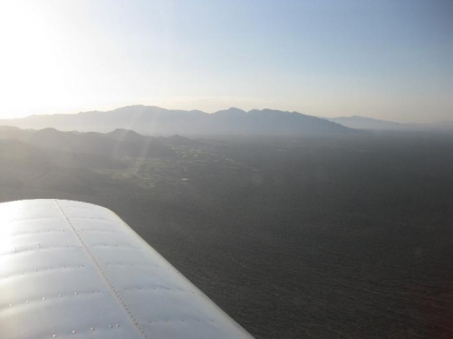 Headed South, looking East at the Catalina mountains in the distance, and Dove mtn closer in.