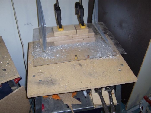 Mess on the router table, chip shield temporarily clamped in place.  (Doubles as belt sander table.)