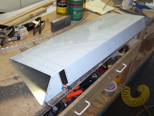 Left aileron skin cut and pilot drilled.
