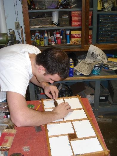 Isaac putting the finish touches on Ellie's birthday present