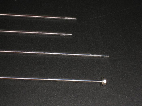 4 rods threaded, one shown with a nuts