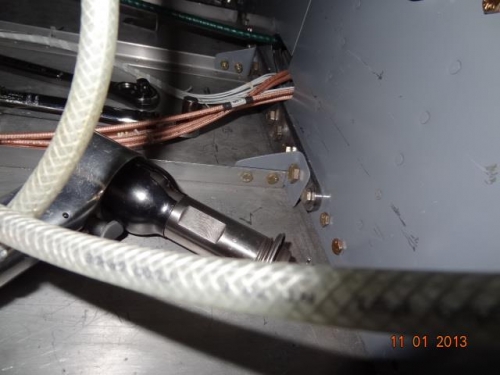 Floor bracket bolted to the inboard left floor stiffener