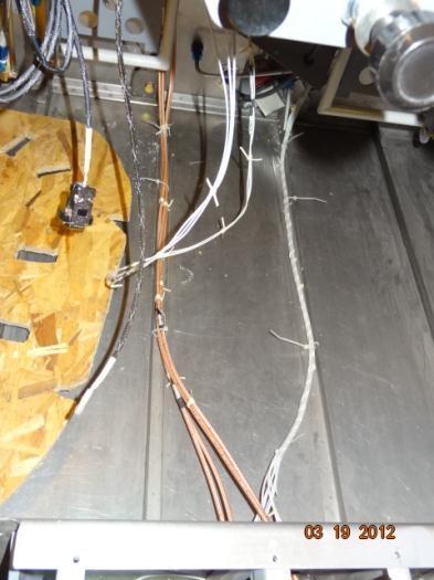 The wires tie-wrapped to the floor