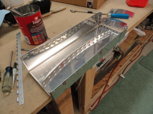 The sides are riveted on and the lower hinge is about to be riveted, incorrectly, to the inside