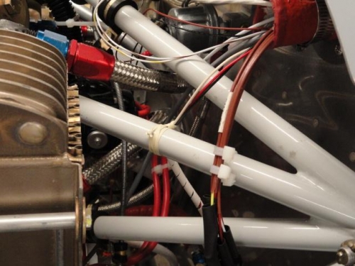 The wires tied to the engine mount with lacing string