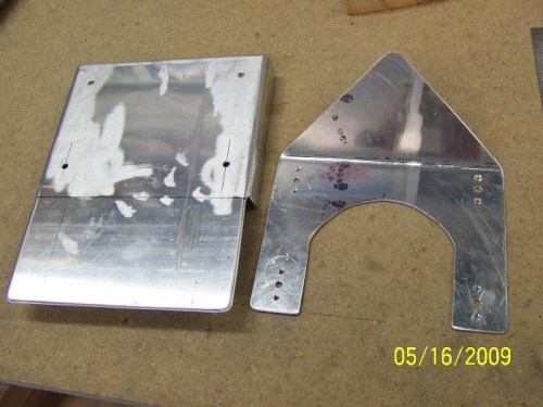 The fuel selector cover on the left and the trim bracket