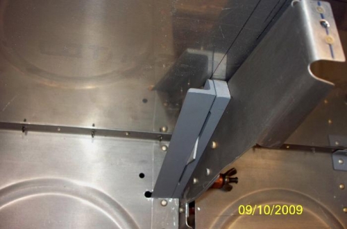 The bracket and wedge under the skin with the support arm installed